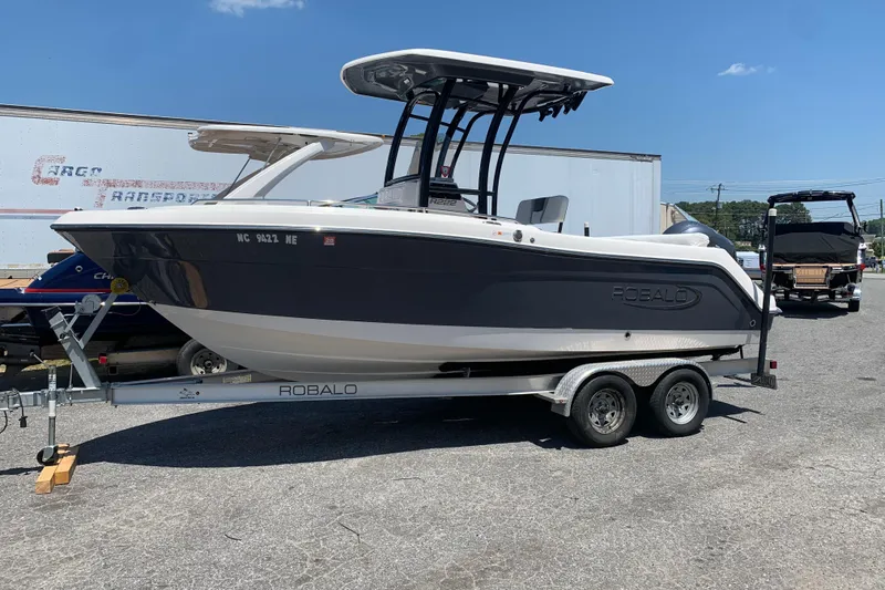 The Image of 2023 Robalo R222 Center Console boat on trailer in outdoor setting. - 0