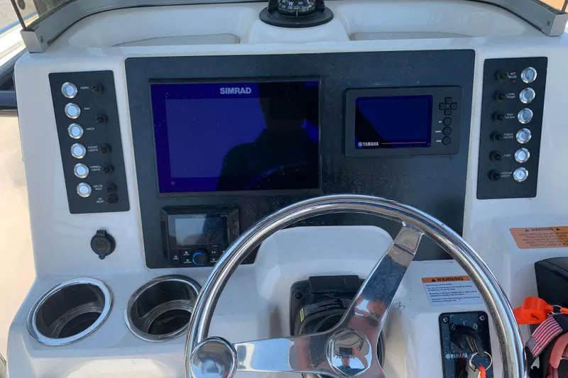Slide: The Image of 2023 Robalo R222 Center Console dashboard with Simrad and Yamaha displays. - 2