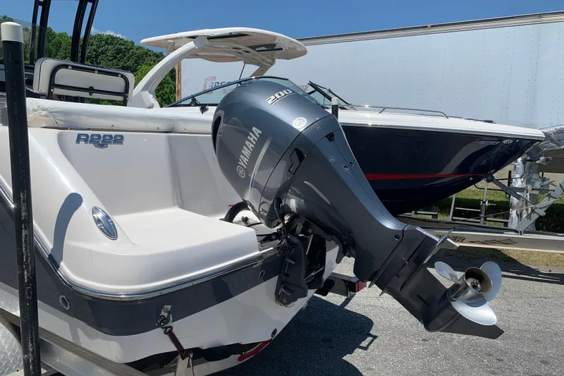 Slide: The Image of 2023 Robalo R222 Center Console boat with Yamaha 200 engine, parked outdoors. - 9