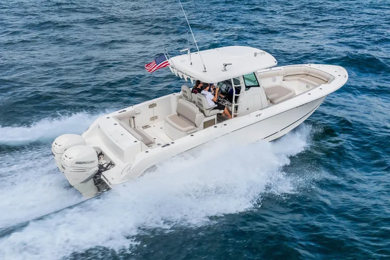 Slide: The Image of 2017 Boston Whaler 330 Outrage cruising on open water with dual Mercury engines. - 15