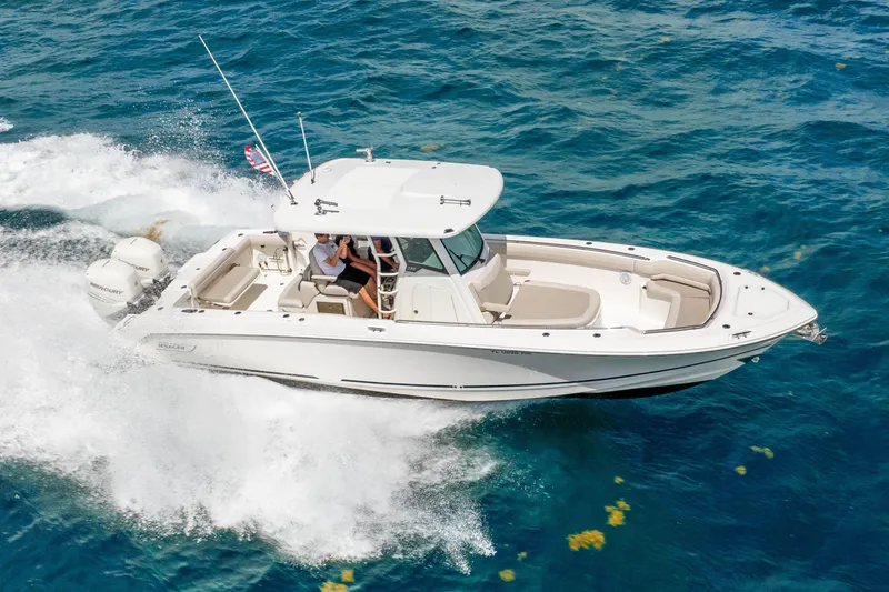 Slide: The Image of 2017 Boston Whaler 330 Outrage cruising on open blue water. - 16