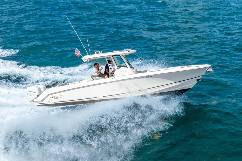 Slide: The Image of 2017 Boston Whaler 330 Outrage cruising on open water, showcasing speed and performance. - 17