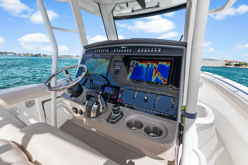 Slide: The Image of Cockpit of 2017 Boston Whaler 330 Outrage with advanced navigation displays on open water. - 18