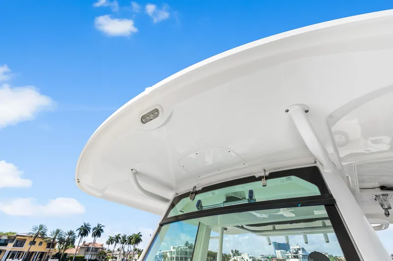 Slide: The Image of Boston Whaler 330 Outrage 2017 boat canopy against a clear blue sky. - 32