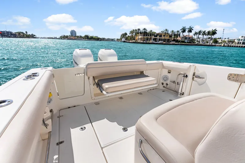 Slide: The Image of 2017 Boston Whaler 330 Outrage boat interior with seating, overlooking scenic waterfront. - 38