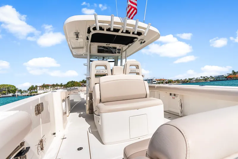 Slide: The Image of 2017 Boston Whaler 330 Outrage boat interior with seating, ocean view, and blue sky. - 40