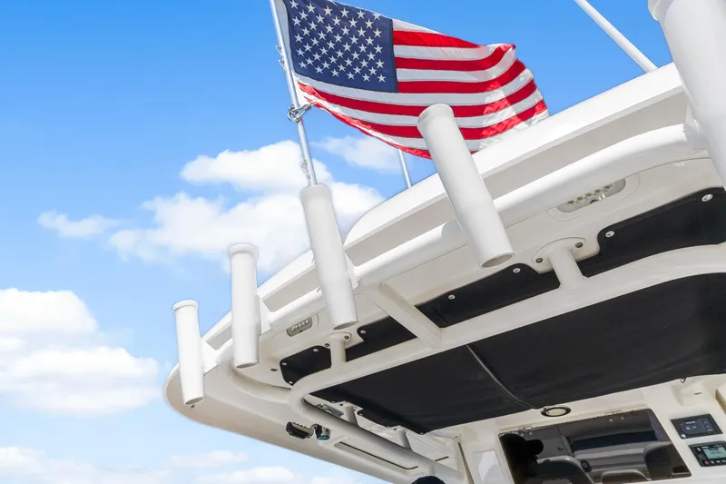 Slide: The Image of Boston Whaler 330 Outrage 2017 boat with American flag against blue sky. - 44