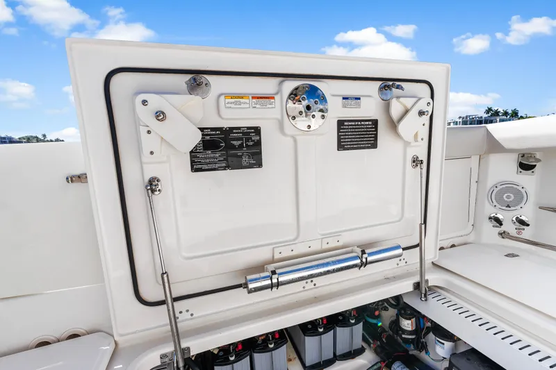 Slide: The Image of 2017 Boston Whaler 330 Outrage boat interior, showcasing storage compartment and control panel. - 48