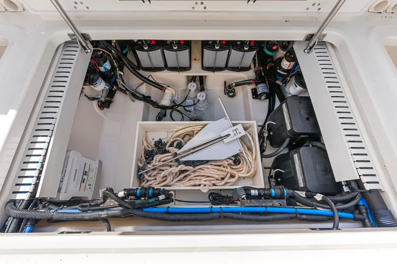 Slide: The Image of 2017 Boston Whaler 330 Outrage boat storage compartment with ropes and equipment. - 49