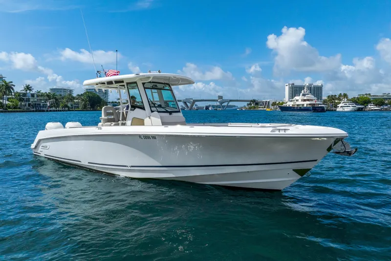 Slide: The Image of 2017 Boston Whaler 330 Outrage boat cruising on a sunny day in a scenic harbor. - 6