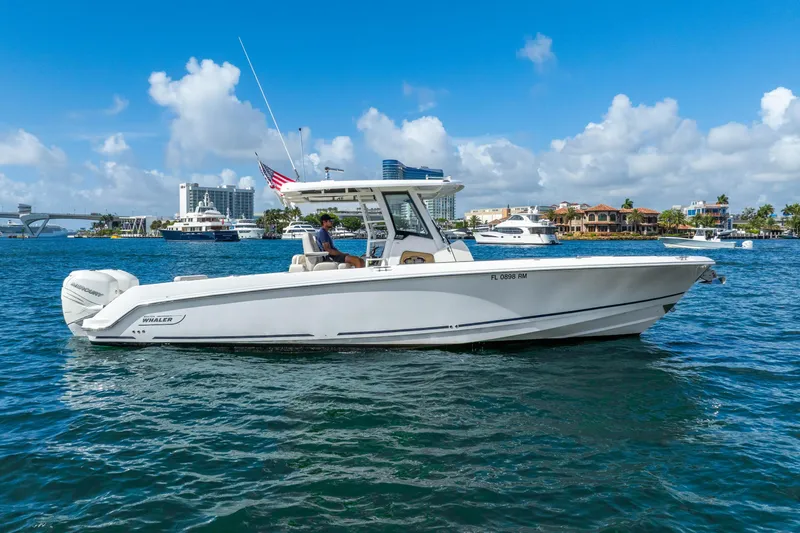 Slide: The Image of 2017 Boston Whaler 330 Outrage boat cruising on a sunny day in a marina. - 7