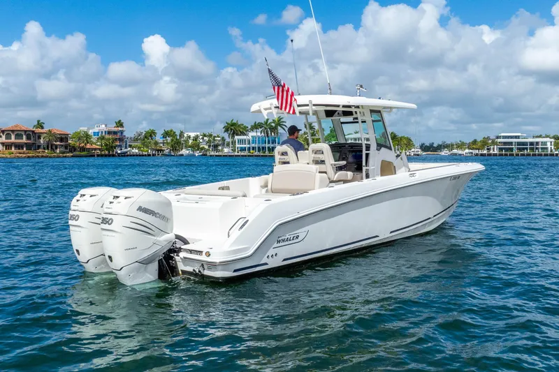 Slide: The Image of 2017 Boston Whaler 330 Outrage boat cruising on a sunny day with twin Mercury engines. - 8