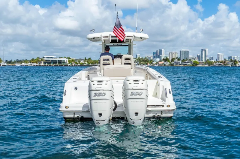 Slide: The Image of 2017 Boston Whaler 330 Outrage boat on water, city skyline in background. - 9