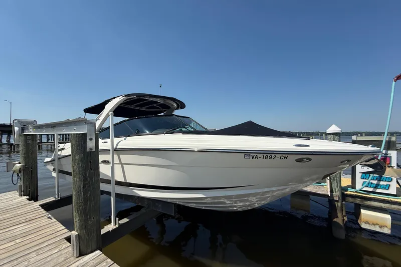 Slide: The Image of 2011 Sea Ray 270 SLX boat docked at marina under clear blue sky. - 0