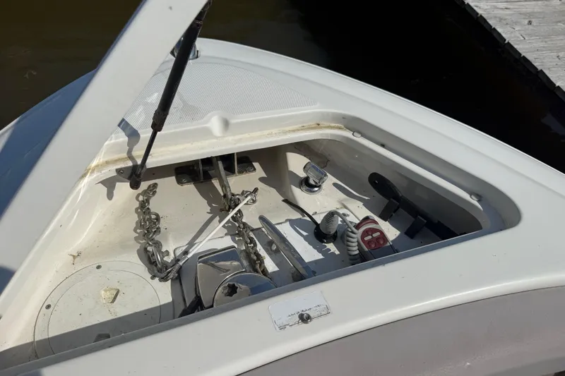 Slide: The Image of Open anchor compartment on a 2011 Sea Ray 270 SLX boat, showing chain and winch. - 13