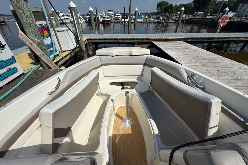 Slide: The Image of 2011 Sea Ray 270 SLX boat interior at marina dock, featuring spacious seating. - 14