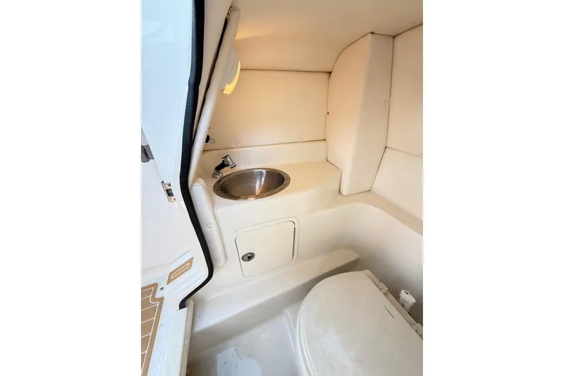 Slide: The Image of Interior of 2011 Sea Ray 270 SLX boat featuring compact bathroom amenities. - 17