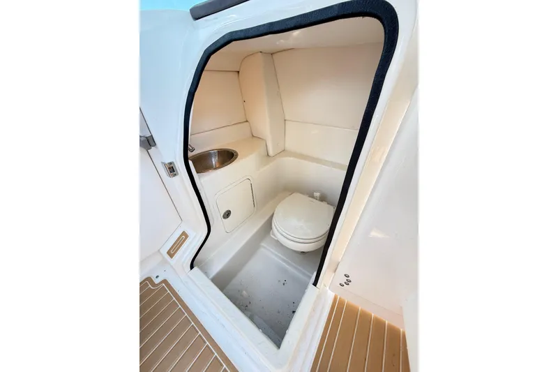 Slide: The Image of Interior of 2011 Sea Ray 270 SLX boat bathroom with toilet and sink. - 18