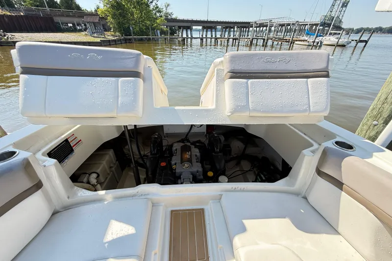 Slide: The Image of 2011 Sea Ray 270 SLX boat engine compartment with open seating, dockside view. - 20