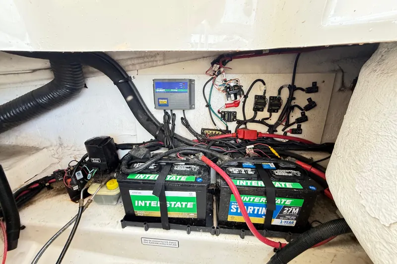 Slide: The Image of Battery compartment of a 2011 Sea Ray 270 SLX with Interstate batteries and wiring. - 23