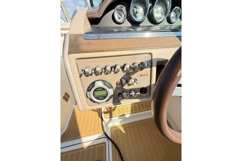 Slide: The Image of Dashboard of a 2011 Sea Ray 270 SLX boat with control panel and gauges. - 28