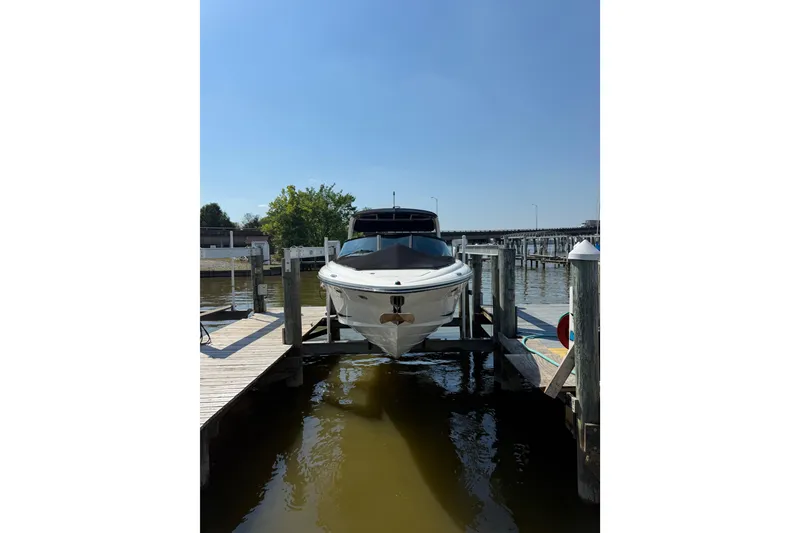 Slide: The Image of 2011 Sea Ray 270 SLX boat docked at a marina under clear blue skies. - 3
