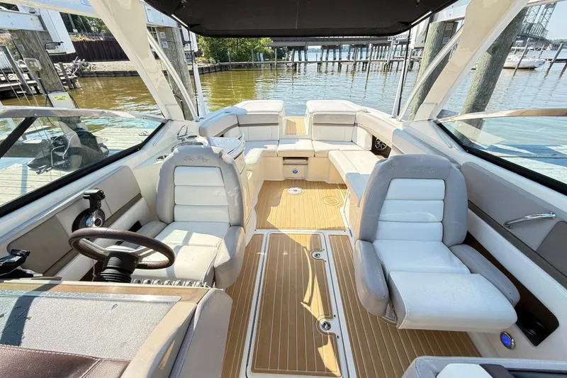 Slide: The Image of Interior view of a 2011 Sea Ray 270 SLX boat with luxurious seating and wood flooring. - 30