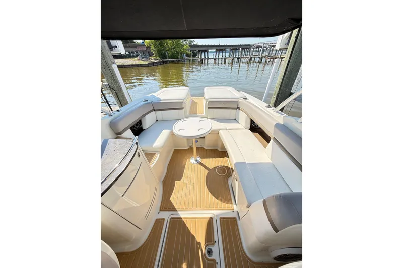Slide: The Image of Spacious seating area on a 2011 Sea Ray 270 SLX boat docked by the water. - 33