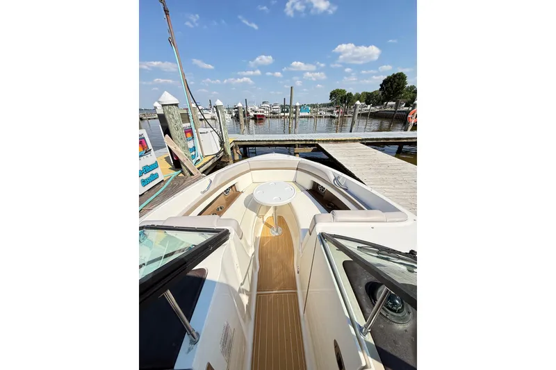 Slide: The Image of 2011 Sea Ray 270 SLX boat docked at marina under blue sky. - 34