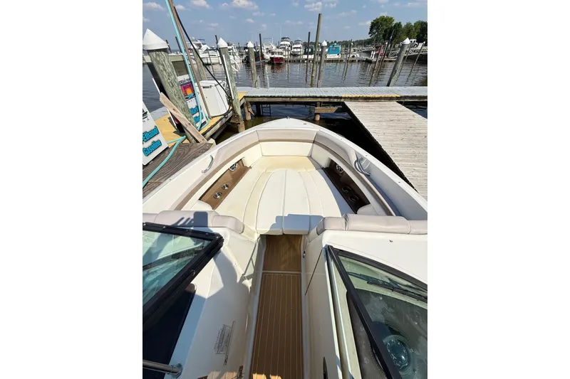 Slide: The Image of 2011 Sea Ray 270 SLX boat docked at marina, featuring spacious seating and sleek design. - 37