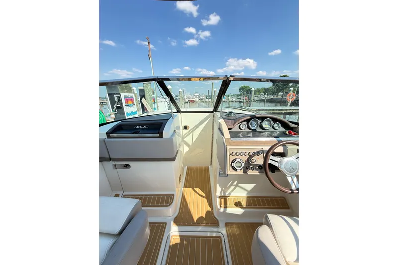 Slide: The Image of Interior view of 2011 Sea Ray 270 SLX boat cockpit with steering wheel and dashboard. - 39