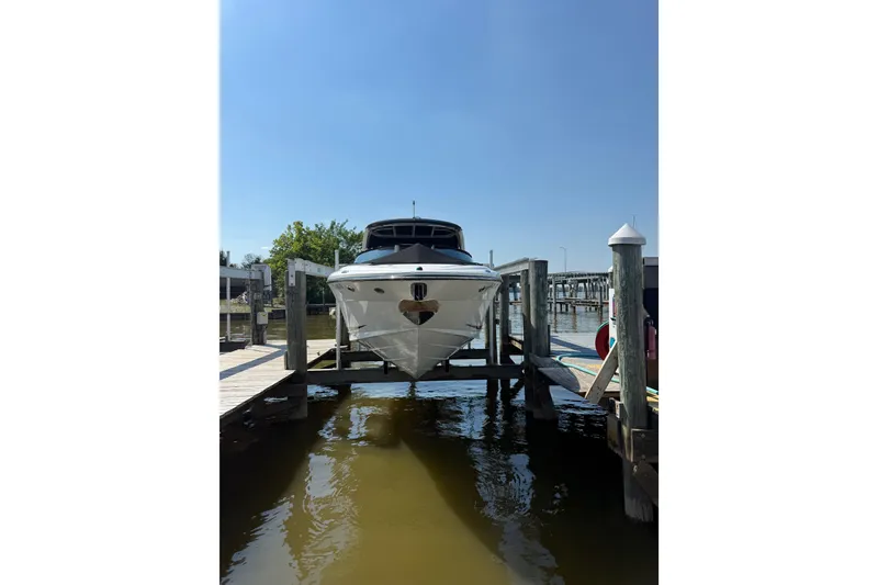 Slide: The Image of 2011 Sea Ray 270 SLX boat docked at a marina under clear blue skies. - 4