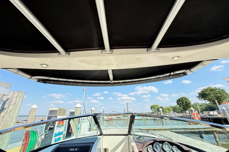 Slide: The Image of 2011 Sea Ray 270 SLX boat interior view at a sunny marina. - 41