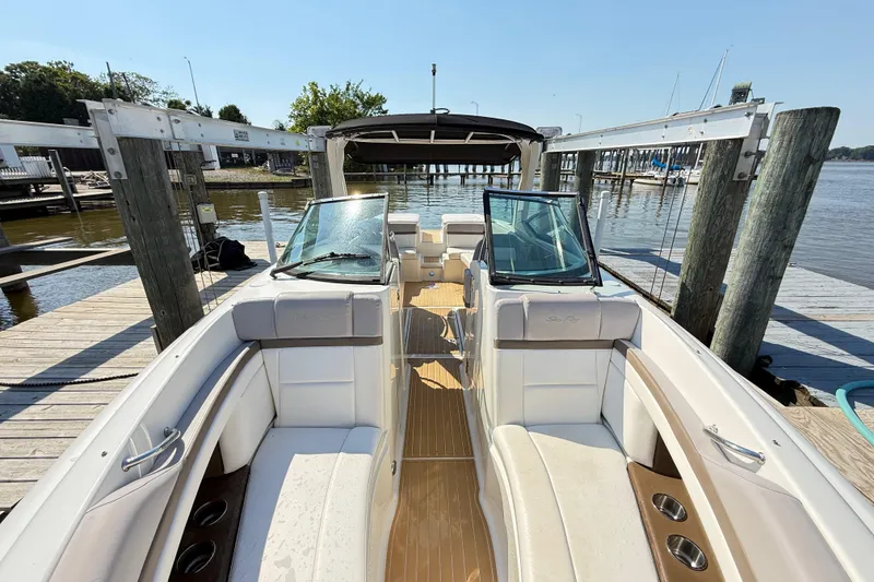 Slide: The Image of 2011 Sea Ray 270 SLX boat docked, featuring spacious seating and sleek design. - 42