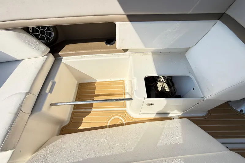 Slide: The Image of 2011 Sea Ray 270 SLX boat interior with storage compartment and seating. - 46