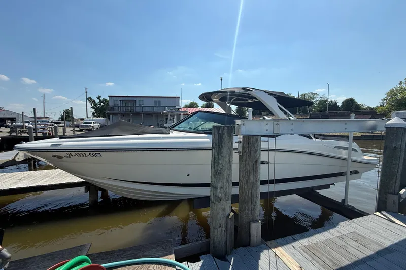 The Image of 2011 Sea Ray 270 SLX boat docked at a marina under clear blue skies. - 5