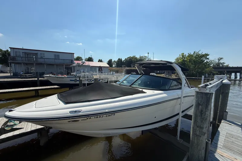 Slide: The Image of 2011 Sea Ray 270 SLX boat docked at a marina under clear skies. - 6