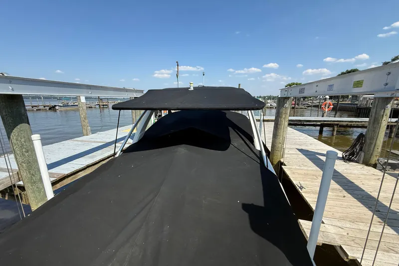Slide: The Image of Covered 2011 Sea Ray 270 SLX boat docked at a marina under a clear blue sky. - 7