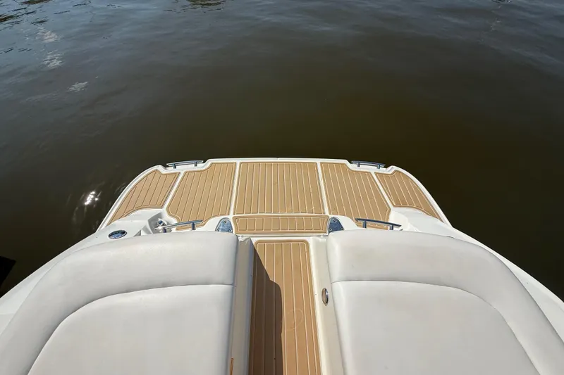 Slide: The Image of 2011 Sea Ray 270 SLX boat deck with teak flooring, overlooking calm water. - 8