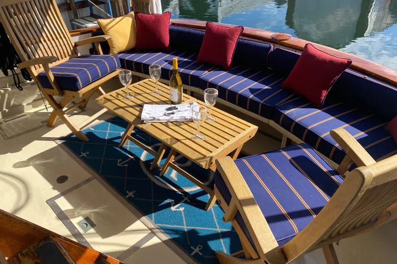 Slide: The Image of Luxurious 1939 Elco Motor Yacht deck with elegant seating and wine setup. - 1