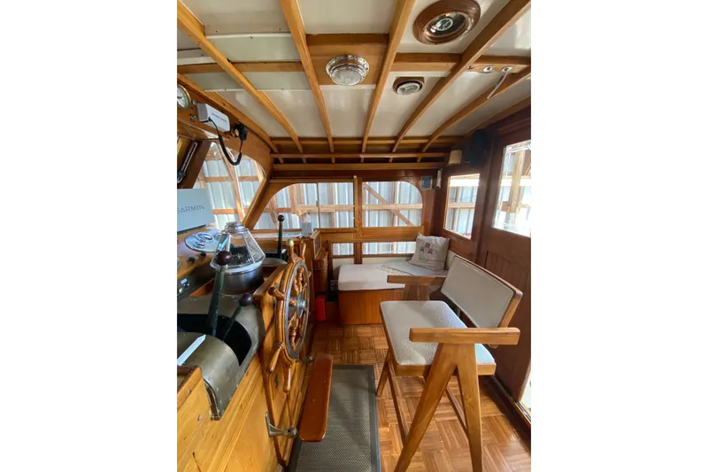 Slide: The Image of Interior of a 1939 Elco Motor Yacht with wooden helm and seating. - 13