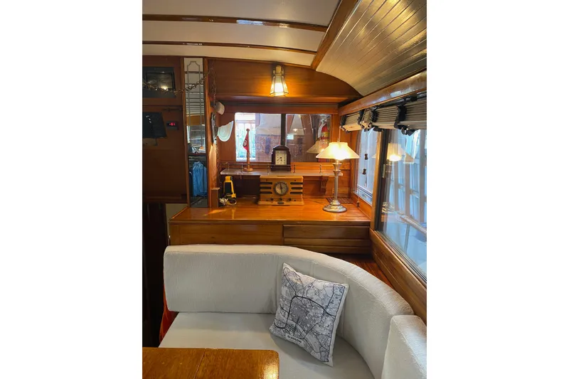 Slide: The Image of Interior of a 1939 Elco Motor Yacht with wooden decor and cozy seating. - 14