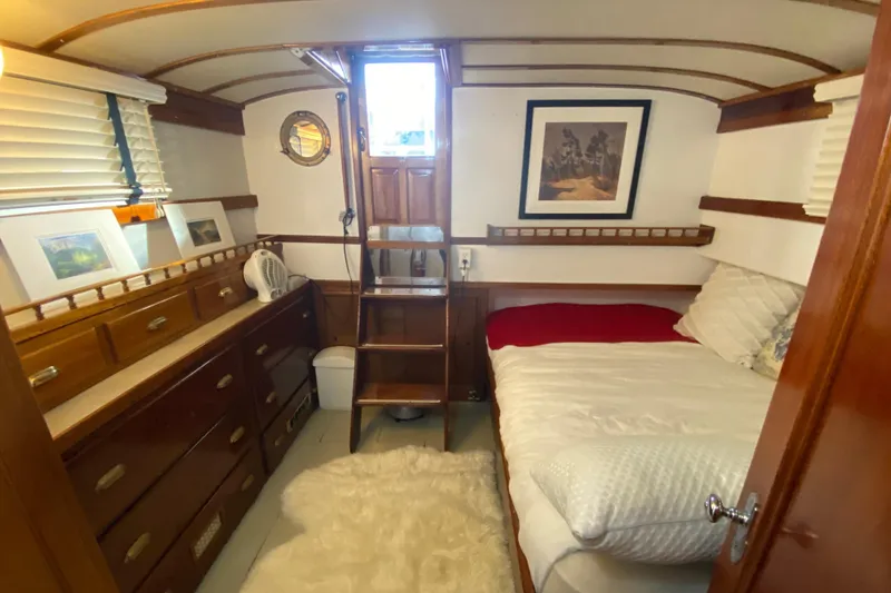Slide: The Image of Cozy 1939 Elco Motor Yacht cabin with wooden interior, bed, and nautical decor. - 24