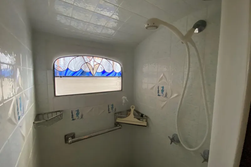 Slide: The Image of Shower area in 1939 Elco Motor Yacht with stained glass window and nautical tiles. - 25