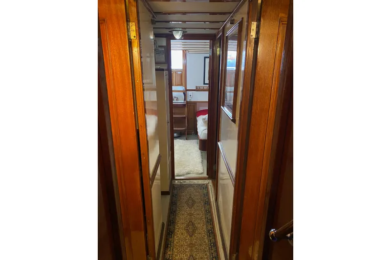 Slide: The Image of Narrow wooden hallway inside a 1939 Elco Motor Yacht, featuring vintage decor. - 27