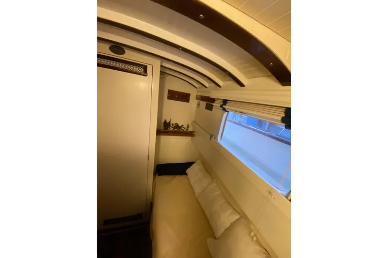 Slide: The Image of Interior cabin of a 1939 Elco Motor Yacht, featuring cozy seating and classic wooden accents. - 31