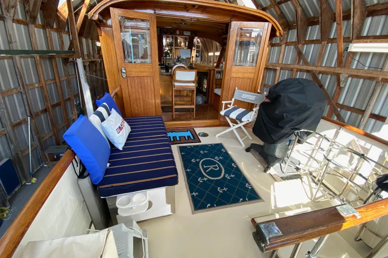 Slide: The Image of 1939 Elco Motor Yacht interior with seating, wooden cabin, and nautical decor. - 4