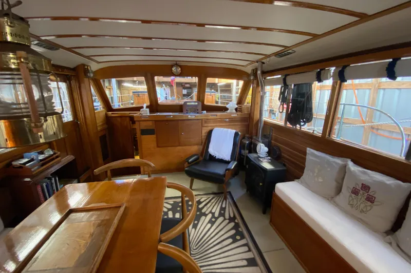 Slide: The Image of Interior of a 1939 Elco Motor Yacht with wooden furnishings and cozy seating. - 5
