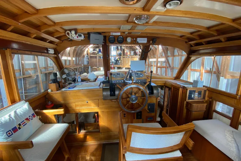 Slide: The Image of Interior of a 1939 Elco Motor Yacht with wooden helm and vintage controls. - 6