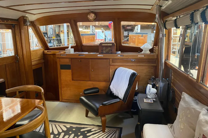 Slide: The Image of Interior of a 1939 Elco Motor Yacht with vintage wooden furnishings and cozy seating. - 9